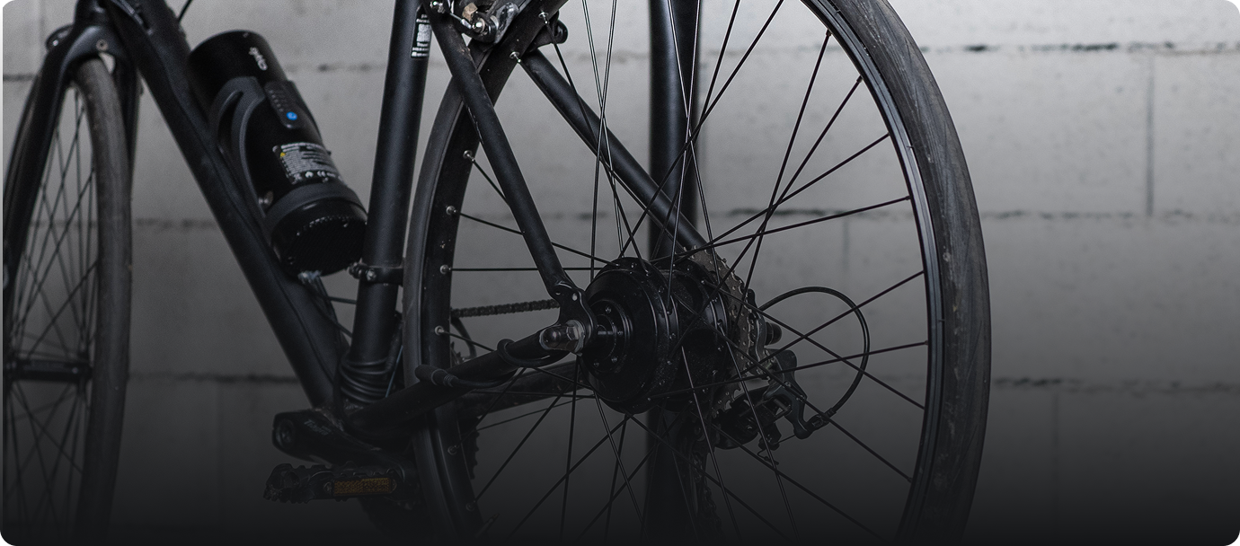 Roue arrière de vélo noir avec moteur électrique.