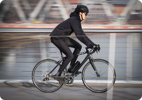 Cycliste en déplacement sur un pont.
